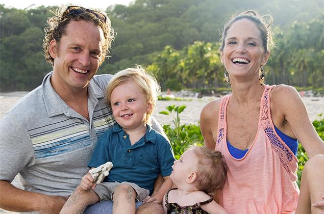 Founders of LuvBelly prenatal powder outside with their children.